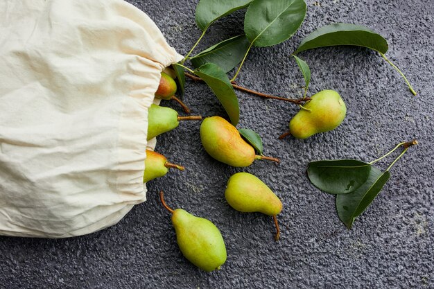 Fresh ripe pears in reusable shopping bag