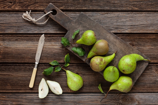 Fresh ripe pears on the vintage wooden board.