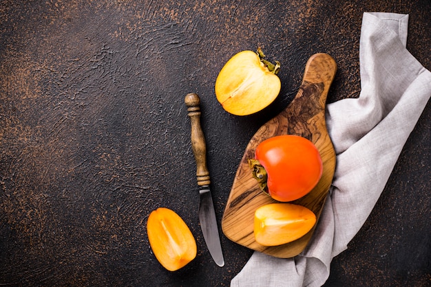 Fresh ripe persimmon on cutting board