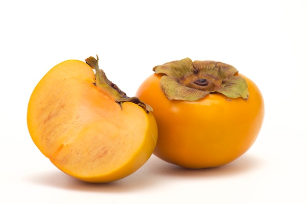 Fresh Ripe persimmon and Slice persimmon on white isolated surface