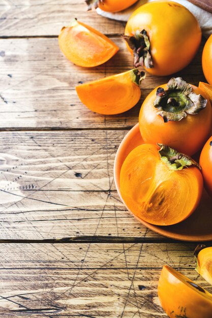 Fresh ripe persimmon on a wooden table