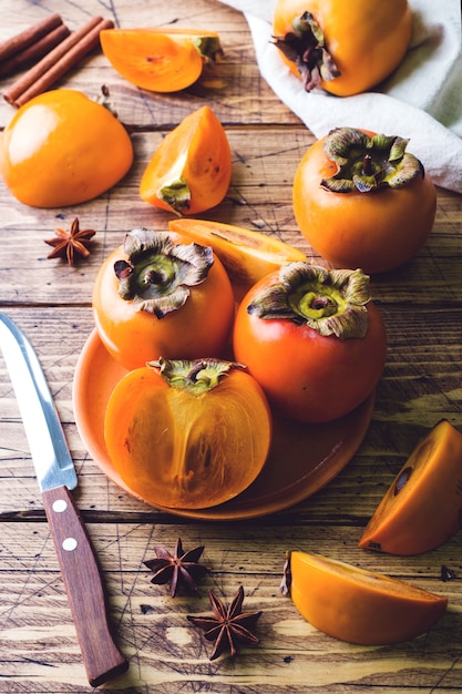 Fresh ripe persimmon on a wooden table