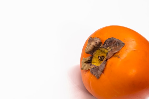 Fresh ripe persimmons on white background