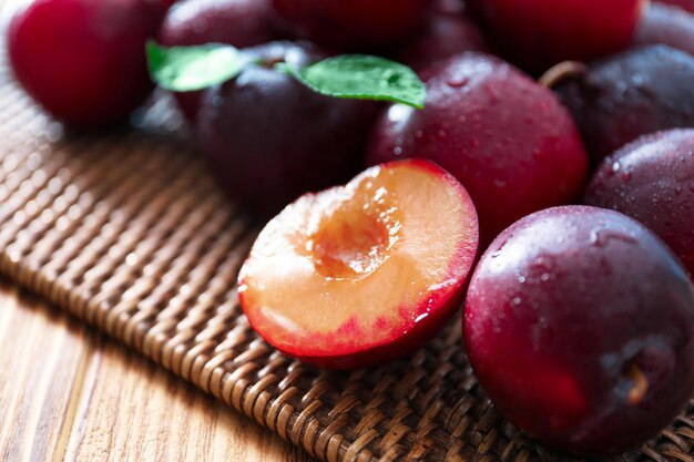 Fresh ripe plums on table closeup