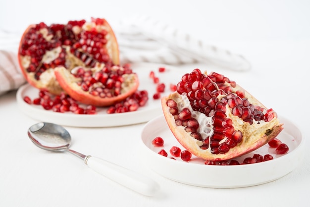 Fresh ripe pomegranate in a plate, pomegranate seeds