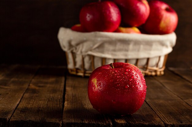 Fresh ripe red apples on a wooden table side view vegetarian\
delicious product in a rustic style