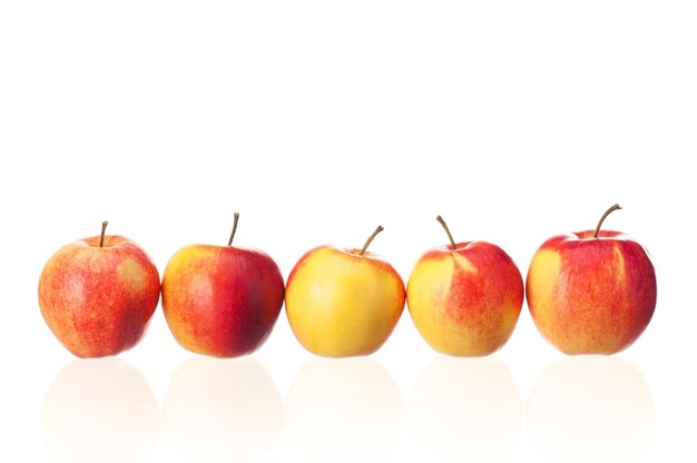 Fresh ripe red and yellow apples on white background