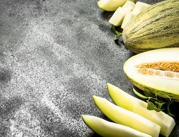 Fresh ripe sliced melon. On a rustic background.