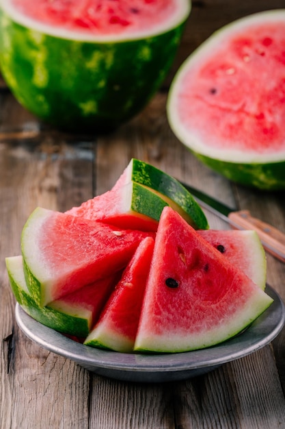 Fresh ripe sliced watermelon on wooden rustic background