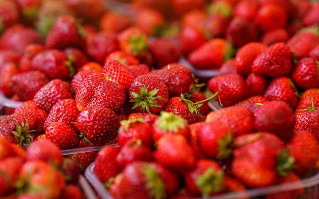 Fresh ripe strawberries displayed on market, closeup detail