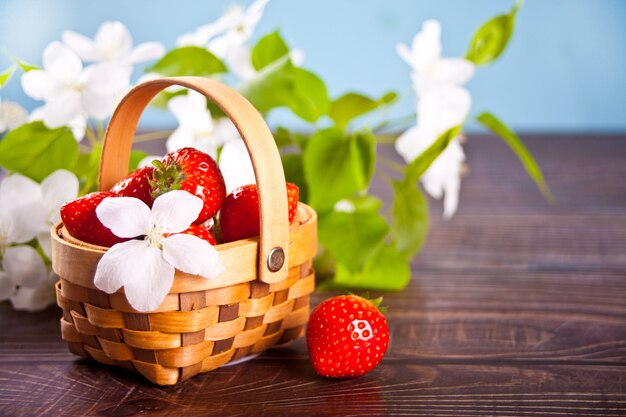 Fresh ripe strawberries in a tiny basket