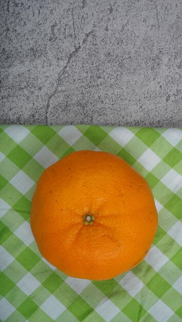 Fresh ripe tangerines on green napkin flat lay space for text