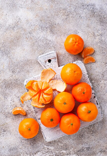 Fresh ripe tangerines on light background