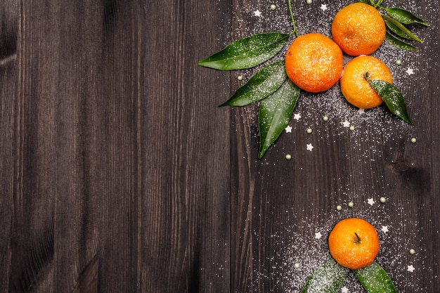 Fresh ripe tangerines with leaves and sprinkles.