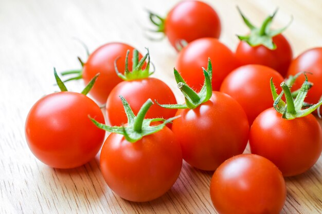 fresh, ripe tomatoes on wood table