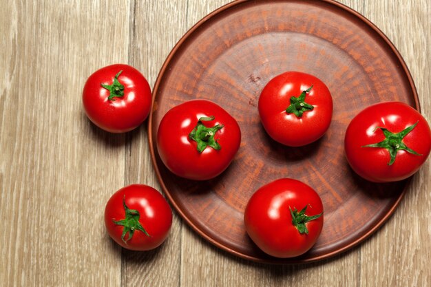 Fresh ripe tomatoes on a wooden