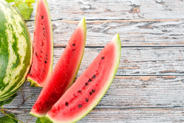 Fresh ripe watermelon Melon On a white wooden background Free space for text Top view