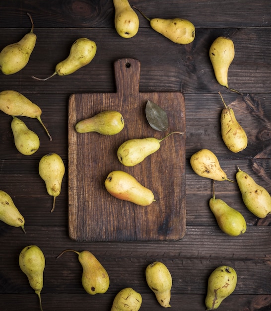 Fresh ripe yellow pears on brown wooden table