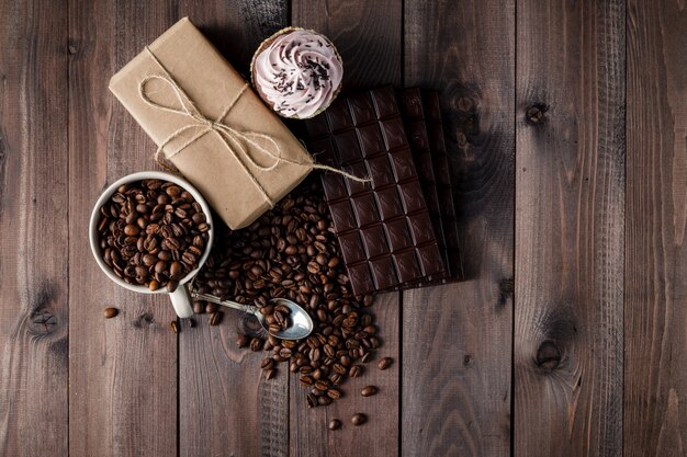 Fresh roasted coffee beans and stack of brown chocolate