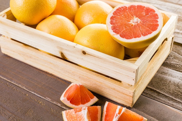 Fresh ruby red grapefruits in wood crate.