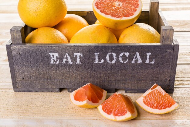 Fresh ruby red grapefruits in wood crate.