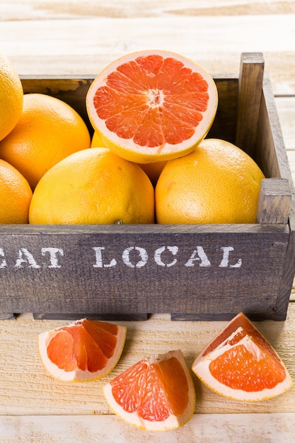 Fresh ruby red grapefruits in wood crate.