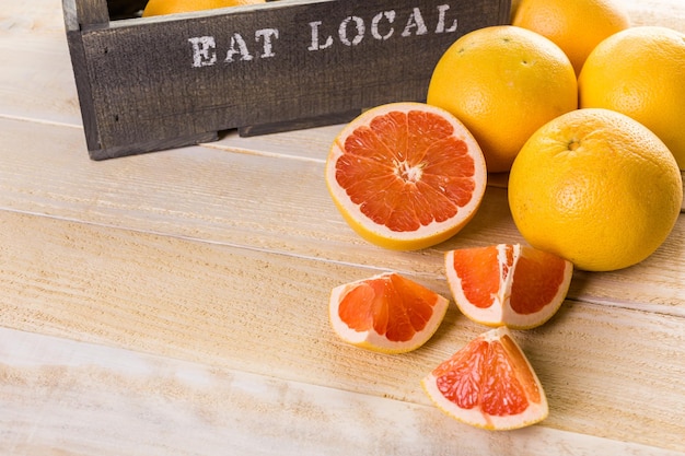 Fresh ruby red grapefruits in wood crate.