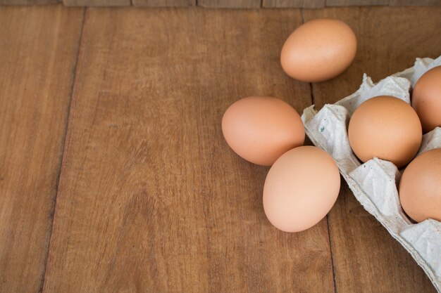 Fresh rural eggs on a wooden board