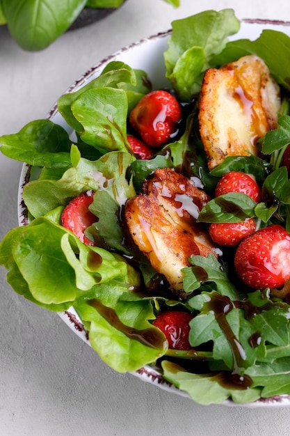 fresh salad of arugula plant cheese basil and strawberry Top view food Healthy vegetarian
