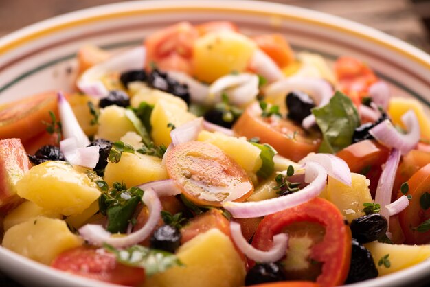 Fresh salad in bowl on table