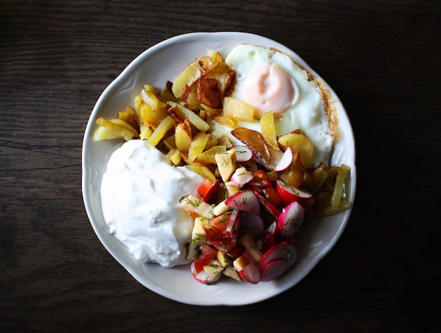 Fresh salad cottage cheese and fried egg on a plate