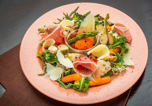 Fresh salad from vegetables, cheese and ham