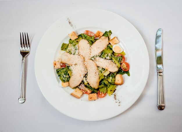 Fresh salad on the white plate. Restaurant.