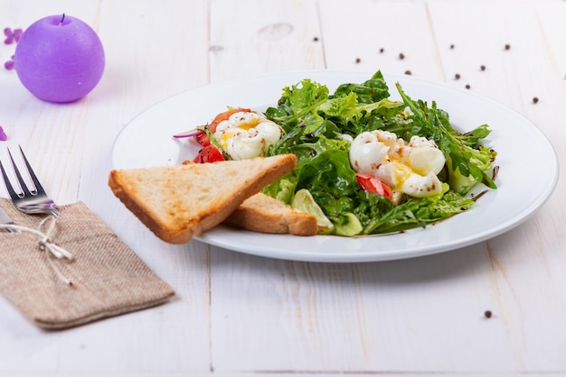 Fresh salad with arugula tomato and egg