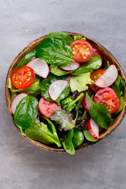 Fresh salad with baby spinach and tomato, radish und salad.