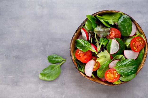 Fresh salad with baby spinach and tomato, radish und salad.