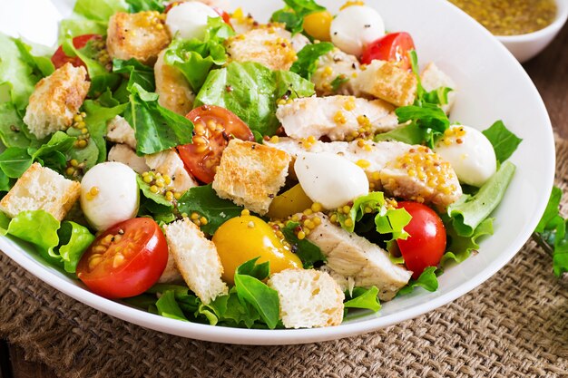 Fresh salad with chicken breast, arugula, lettuce and tomato.