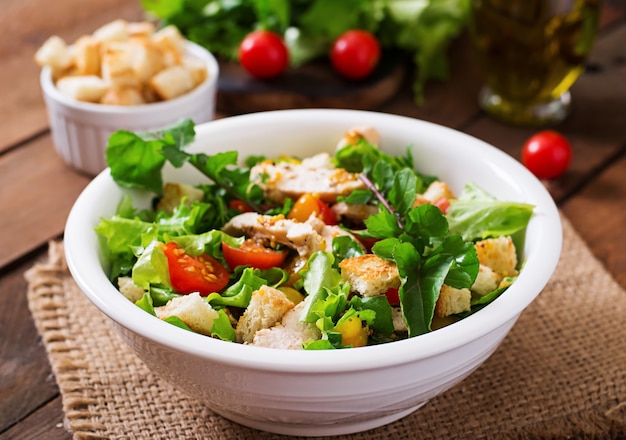 Fresh salad with chicken breast, arugula, lettuce and tomato.