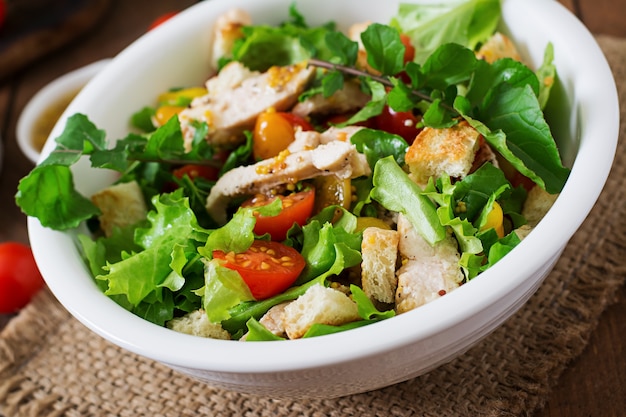 Fresh salad with chicken breast, arugula, lettuce and tomato.