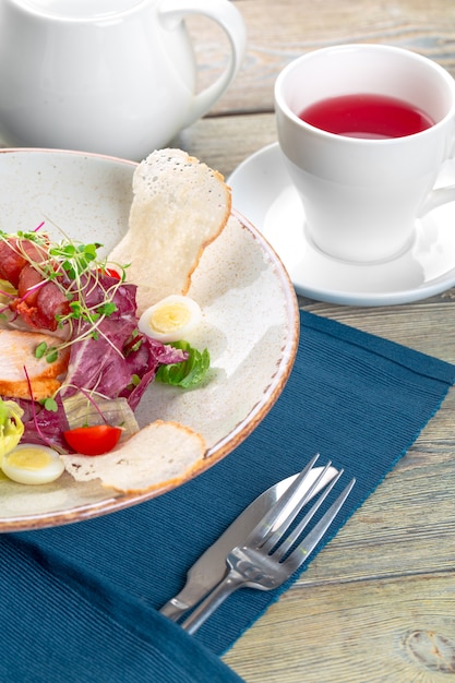 Fresh salad with chicken breast, arugula and tomato. Top view