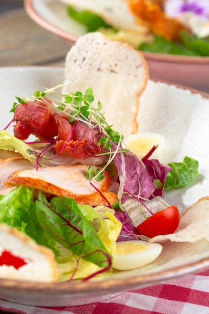 Fresh salad with chicken breast, arugula and tomato