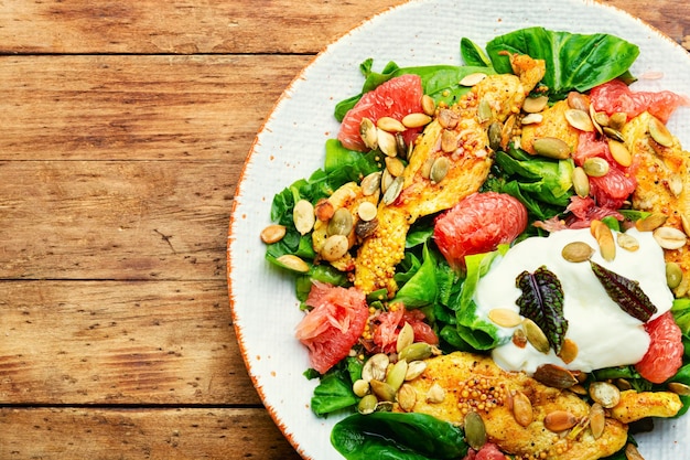 Fresh salad with chicken breast herbs and grapefruit