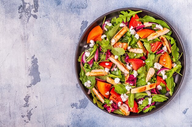 Fresh salad with chicken breast, top view.