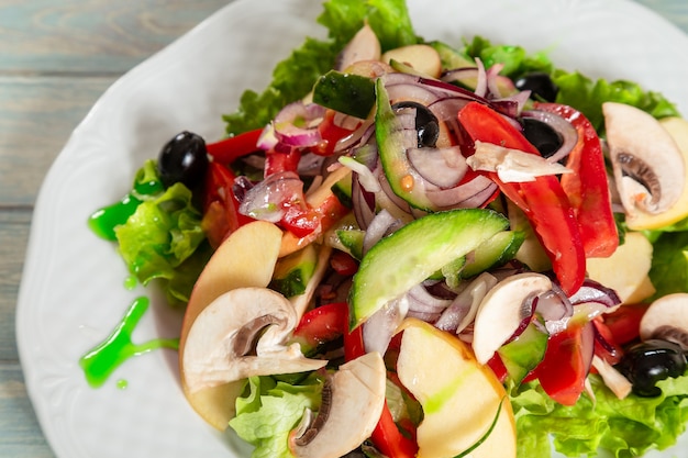 Fresh salad with fruits, vegetables and mushrooms 