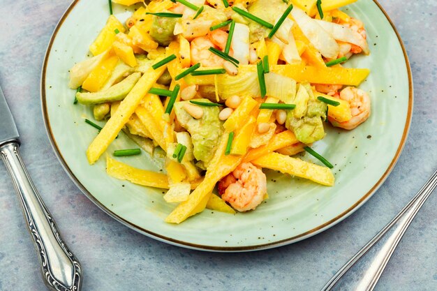 Fresh salad with roasted prawns mango ripe avocado and pine nuts healthy eating