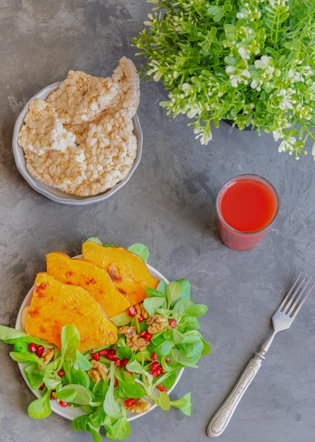 Fresh salad with roasted pumpkin pomegranates seeds and corn lettuce