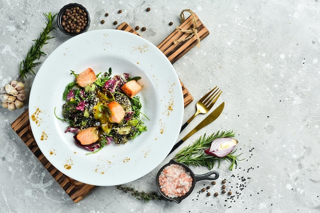 Fresh salad with salmon and quinoa Healthy food On a white plate Rustic style