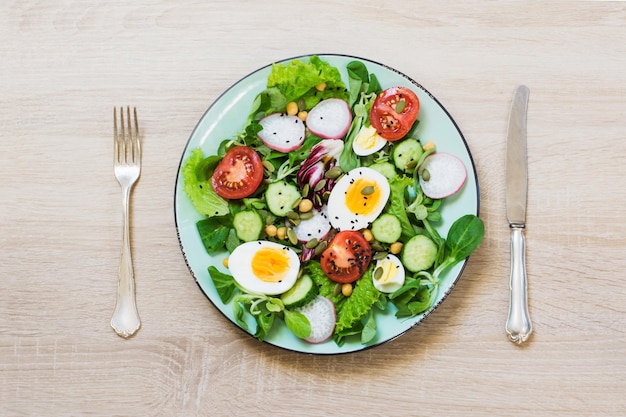 Fresh salad with vegetables and eggs for proper nutrition Top view copy space Diet for weight loss concept Proper nutrition