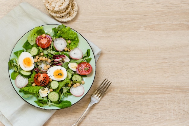 Fresh salad with vegetables and eggs for proper nutrition Top view copy space