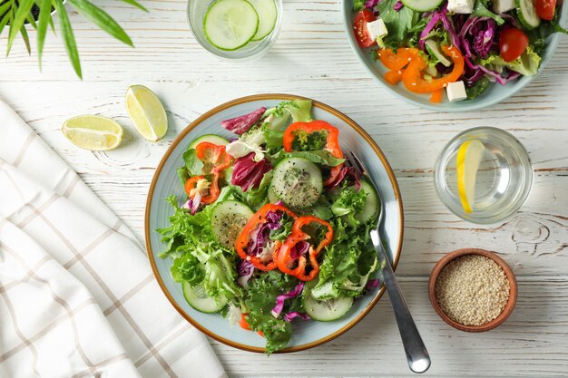 Fresh salads with spices on rustic wooden